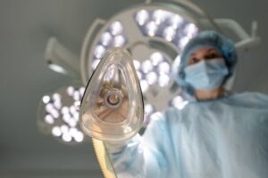 Surgeon holding an anesthesia mask in an operating room before surgery